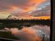 Stunning sunset view over a tranquil lake with lush vegetation at 14271 Heritage Landing Blvd # 1526, Punta Gorda, FL 33955