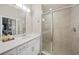 Bathroom with white vanity, large mirror, and walk-in shower at 14271 Heritage Landing Blvd # 1526, Punta Gorda, FL 33955