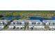 Aerial view of a row of townhouses with attached garages near a lake at 14271 Heritage Landing Blvd # 1526, Punta Gorda, FL 33955