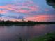 Stunning sunset view over a calm lake at 14271 Heritage Landing Blvd # 1526, Punta Gorda, FL 33955