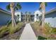 Peaceful courtyard with a walkway, landscaping, and two-story building at 14271 Heritage Landing Blvd # 1526, Punta Gorda, FL 33955