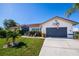 Lovely single-story home with a beautiful lawn, a two-car garage, and an inviting facade at 1542 Kinglet Dr, Punta Gorda, FL 33950