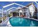 Beautiful screened-in pool with waterfront view, lounge chairs, and nearby hot tub at 1542 Kinglet Dr, Punta Gorda, FL 33950