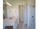 Bright bathroom featuring a white vanity, large mirror, and glass shower at 17263 Tampico Ln, Punta Gorda, FL 33955