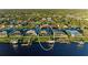 Aerial view showcasing a waterfront house with a pool and dock at 17389 Ohara Dr, Port Charlotte, FL 33948