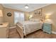 Bedroom with a queen bed, light wood floors, and ceiling fan at 2000 Bal Harbor Blvd # 321, Punta Gorda, FL 33950