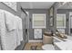 Modern bathroom with a glass shower door, tiled floors, and ample storage at 2000 Bal Harbor Blvd # 321, Punta Gorda, FL 33950