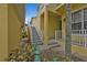 Exterior view of a staircase leading to the yellow condo entrance, providing access to the upper-level units at 2000 Bal Harbor Blvd # 321, Punta Gorda, FL 33950