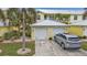 Attached two-car garage with a paved driveway and a parked silver SUV, showcasing convenience and ample parking at 2000 Bal Harbor Blvd # 321, Punta Gorda, FL 33950