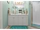Double vanity bathroom with a large mirror and light teal walls at 2000 Bal Harbor Blvd # 321, Punta Gorda, FL 33950
