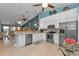 Modern kitchen with white cabinetry, stainless steel appliances, and an open layout to the living and dining areas at 2000 Bal Harbor Blvd # 321, Punta Gorda, FL 33950