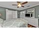 Serene bedroom with a queen bed, white dresser, and plantation shutters at 2000 Bal Harbor Blvd # 321, Punta Gorda, FL 33950