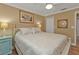 Bedroom with a queen bed, light blue nightstand, and ceiling fan at 2000 Bal Harbor Blvd # 321, Punta Gorda, FL 33950