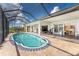 Relaxing pool area with screened enclosure, patio furniture, and a spacious deck at 2241 Gulfview Rd, Punta Gorda, FL 33950