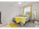 Cozy bedroom with a queen bed and yellow accents at 24004 Vincent Ave, Punta Gorda, FL 33955