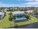 Aerial view of waterfront home with private pool and canal access at 24004 Vincent Ave, Punta Gorda, FL 33955