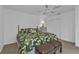 Guest bedroom with leafy bedding, dresser and double doors at 25373 Tether Ln, Punta Gorda, FL 33983