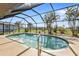 Kidney-shaped pool with screened enclosure at 25373 Tether Ln, Punta Gorda, FL 33983