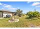 Landscaped backyard with lush tropical plants and a grassy area at 25373 Tether Ln, Punta Gorda, FL 33983
