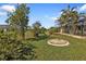 Landscaped backyard with mature trees and a grassy area at 25373 Tether Ln, Punta Gorda, FL 33983