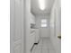 Bright laundry room with washer, dryer, cabinets, and tile floor at 25373 Tether Ln, Punta Gorda, FL 33983