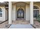 Elegant entryway with double doors, stone flooring, and columns at 25373 Tether Ln, Punta Gorda, FL 33983