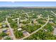 An aerial view of the neighborhood showcasing the property's location surrounded by lush greenery and nearby houses at 2643 Rushmore St, North Port, FL 34288