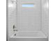 The bathroom tub has white subway tile, a showerhead, and silver hardware at 2643 Rushmore St, North Port, FL 34288