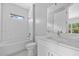 Bathroom with tiled shower/tub, tile flooring, and vanity with quartz counters at 2643 Rushmore St, North Port, FL 34288