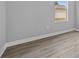 Bedroom featuring a window, light gray walls, and light wood flooring at 2643 Rushmore St, North Port, FL 34288