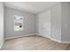 This bedroom offers neutral colors, a window, a closet, and light wood flooring at 2643 Rushmore St, North Port, FL 34288