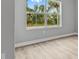 Bedroom with window view of the surrounding landscape and wood-look flooring at 2643 Rushmore St, North Port, FL 34288