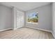 Bright bedroom with wood-look floors, closet and a window offering natural light at 2643 Rushmore St, North Port, FL 34288