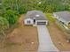 Aerial view of a single-Gathering home with a long driveway and well-maintained landscaping at 2643 Rushmore St, North Port, FL 34288