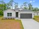 Lovely single-story home with a two-car garage, landscaping and a classic design at 2643 Rushmore St, North Port, FL 34288