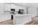 Modern kitchen with white cabinets, stainless steel appliances, quartz countertops and an island for seating at 2643 Rushmore St, North Port, FL 34288