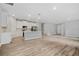 A view from the living area into the open kitchen with modern stainless steel appliances and light gray walls at 2643 Rushmore St, North Port, FL 34288