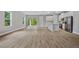 Bright, open-concept living room featuring modern floors that connect to a stylish kitchen and backyard access at 2643 Rushmore St, North Port, FL 34288