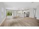 Open-concept living area flowing into a modern kitchen with stainless steel appliances and sliding glass door to the yard at 2643 Rushmore St, North Port, FL 34288