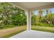 Covered patio overlooking a lush backyard with plenty of trees at 2643 Rushmore St, North Port, FL 34288