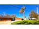 View of the home's side and detached garage, revealing ample space at 301 Country Club Way, Venice, FL 34285