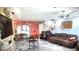 Spacious living room with stone accent wall, large TV, and comfortable seating at 301 Country Club Way, Venice, FL 34285