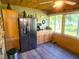 Rustic kitchen with wood cabinets and stainless steel refrigerator at 301 Country Club Way, Venice, FL 34285