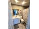 Bathroom with white vanity, shower/tub combo, and gray accents at 301 Country Club Way, Venice, FL 34285