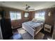Bright bedroom with a queen bed and dark hardwood floors at 301 Country Club Way, Venice, FL 34285
