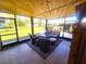 Screened patio with seating area and fire pit at 301 Country Club Way, Venice, FL 34285