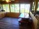 Sunroom with wood walls and large windows overlooking backyard at 301 Country Club Way, Venice, FL 34285