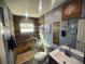 Modern bathroom with wood-like tile and a walk-in shower at 301 Country Club Way, Venice, FL 34285
