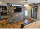 Main bedroom with stone accent wall and hardwood flooring at 301 Country Club Way, Venice, FL 34285
