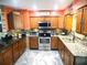 Modern kitchen with granite countertops and stainless steel appliances at 301 Country Club Way, Venice, FL 34285